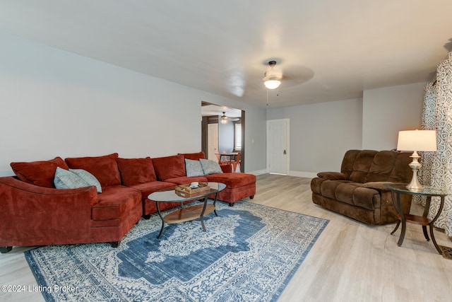 living room with light hardwood / wood-style floors and ceiling fan