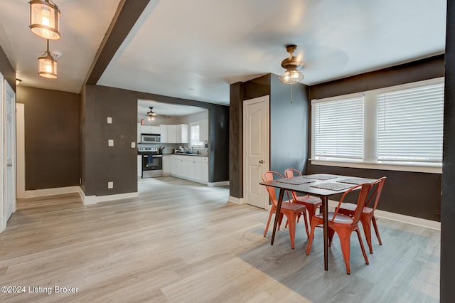 dining room featuring light wood-type flooring and ceiling fan