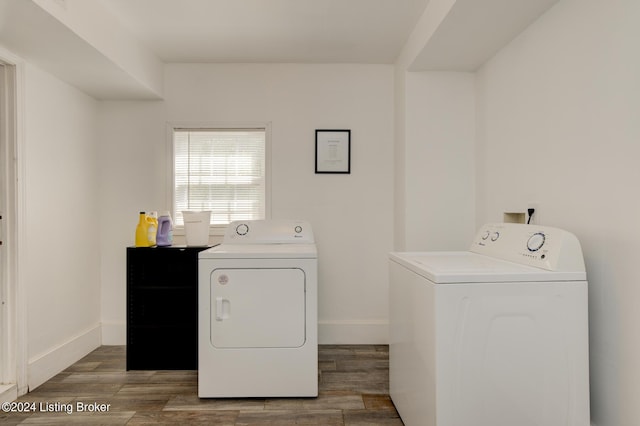 laundry area featuring washing machine and dryer and dark wood-type flooring