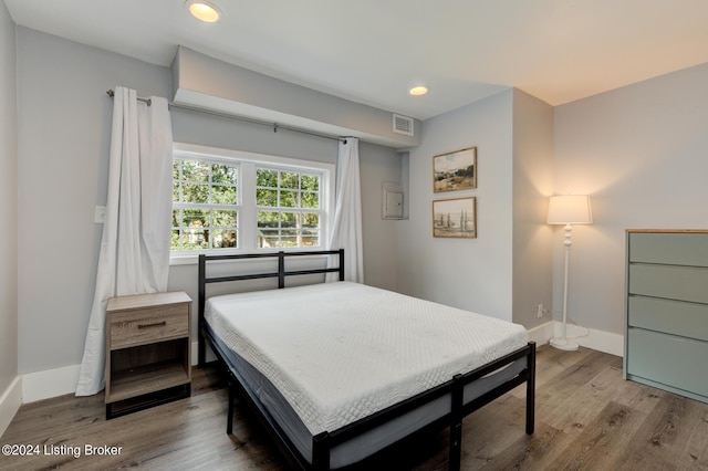 bedroom with wood-type flooring