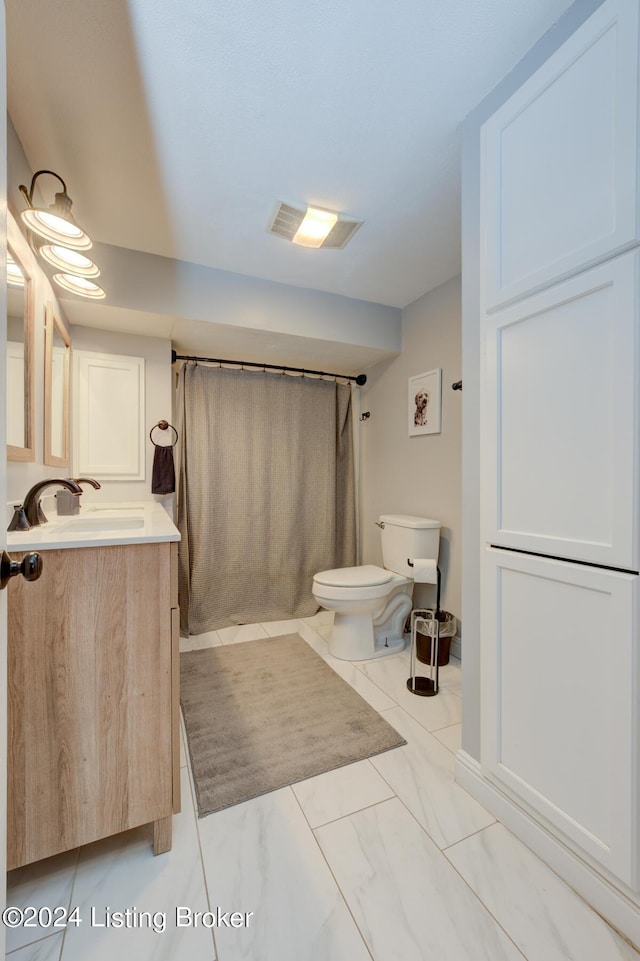 bathroom featuring toilet, vanity, and a shower with shower curtain