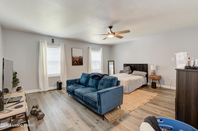 bedroom with ceiling fan and light hardwood / wood-style flooring