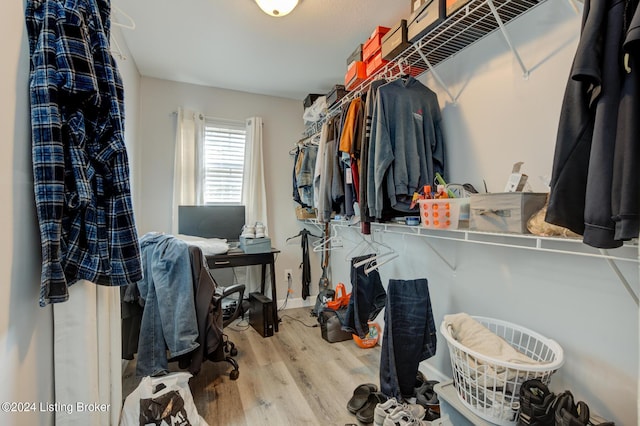 walk in closet with wood-type flooring