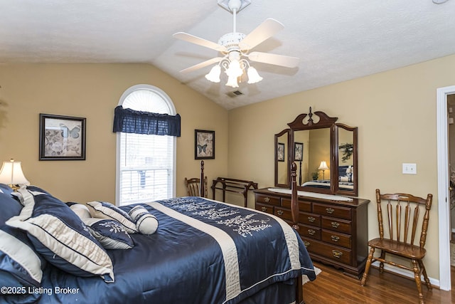 bedroom featuring ceiling fan, dark wood-type flooring, and vaulted ceiling