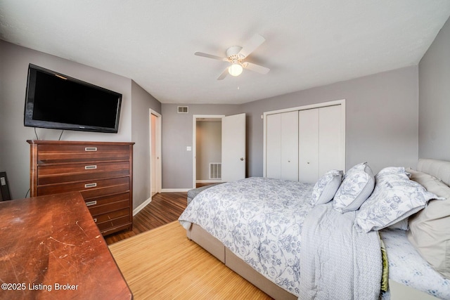 bedroom with ceiling fan, hardwood / wood-style floors, and a closet