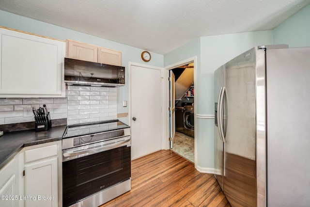 kitchen featuring appliances with stainless steel finishes, backsplash, ventilation hood, light hardwood / wood-style floors, and white cabinets