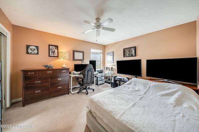 bedroom with light carpet, a textured ceiling, and ceiling fan