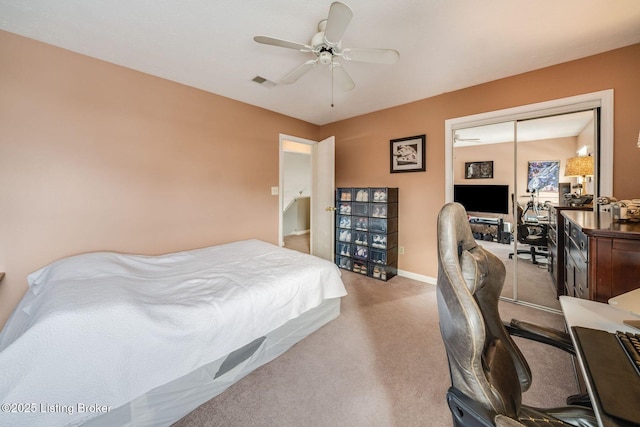 bedroom with ceiling fan, light colored carpet, and a closet