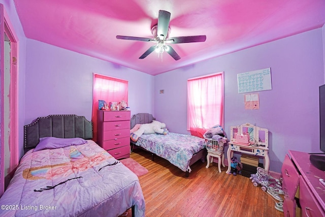 bedroom with ceiling fan and light hardwood / wood-style floors