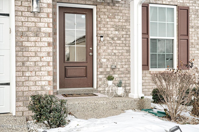 view of snow covered property entrance