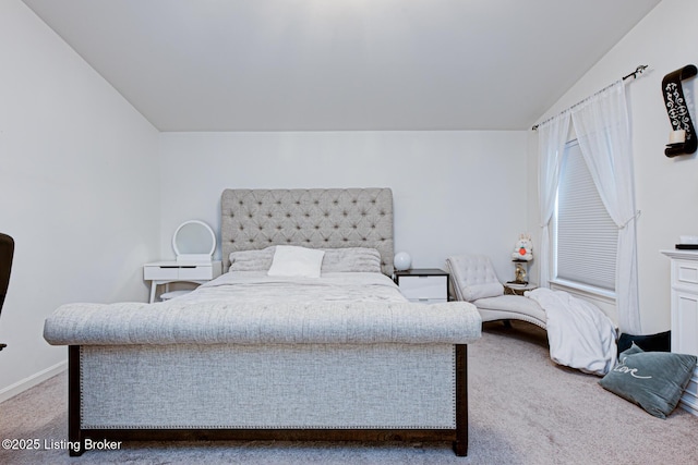 carpeted bedroom featuring vaulted ceiling