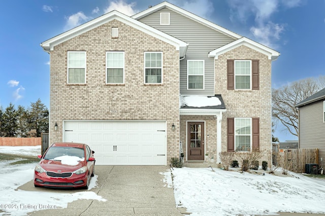 view of front property featuring a garage and central AC unit