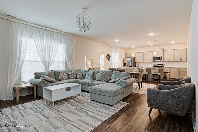 living room featuring sink and hardwood / wood-style floors