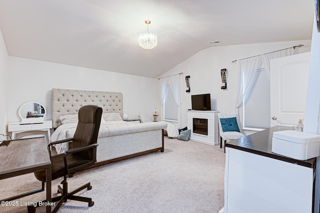 carpeted bedroom with vaulted ceiling and a chandelier