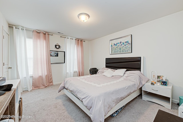 bedroom with light colored carpet