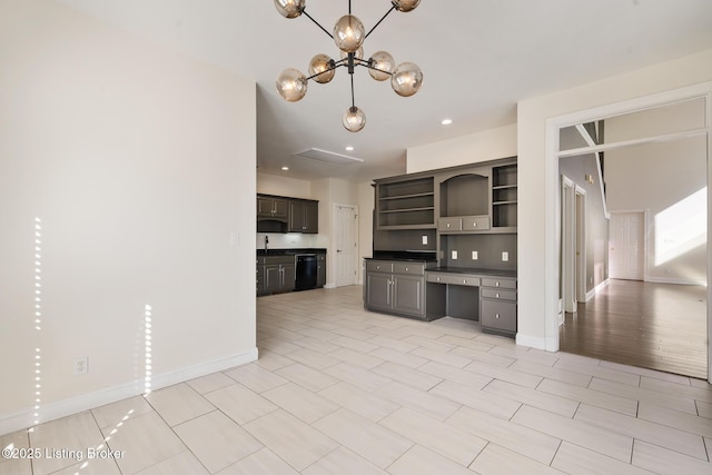 kitchen with light tile patterned flooring, sink, an inviting chandelier, built in desk, and dishwasher