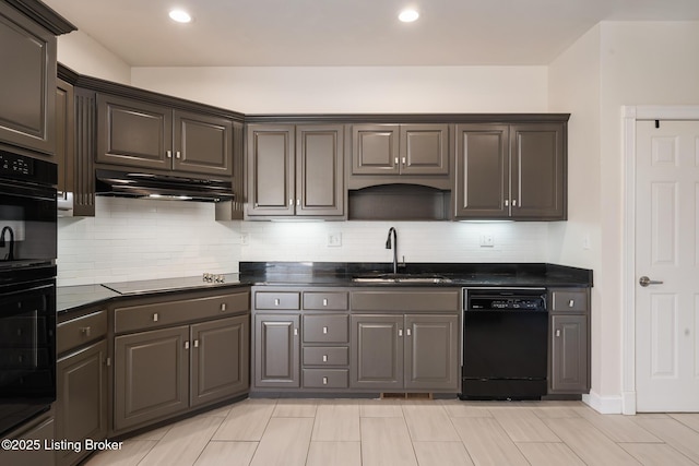 kitchen featuring under cabinet range hood, a sink, decorative backsplash, black appliances, and dark countertops