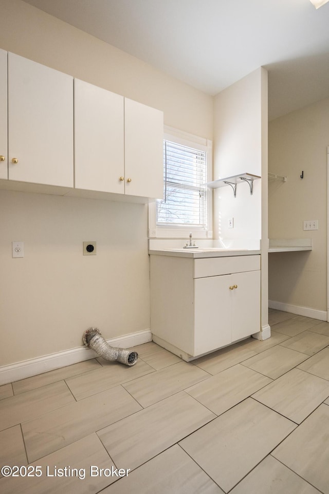 clothes washing area featuring cabinets, sink, and electric dryer hookup