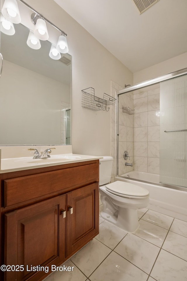 bathroom featuring visible vents, shower / bath combination with glass door, vanity, and toilet