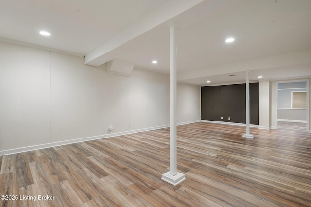 basement with hardwood / wood-style floors