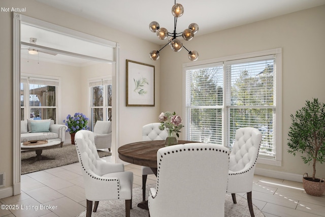 dining space with an inviting chandelier and light tile patterned floors