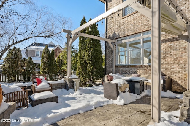 snow covered patio featuring a grill