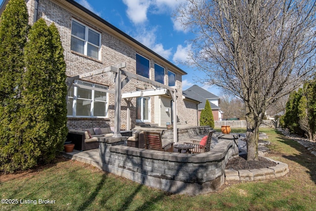 back of house featuring a patio area, fence, a pergola, and brick siding