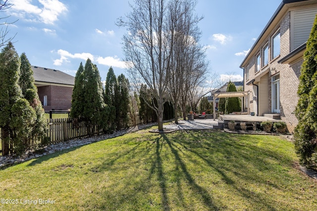 view of yard with a patio area, fence, and a pergola