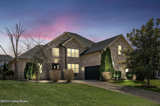 view of front of property featuring a yard, concrete driveway, and brick siding