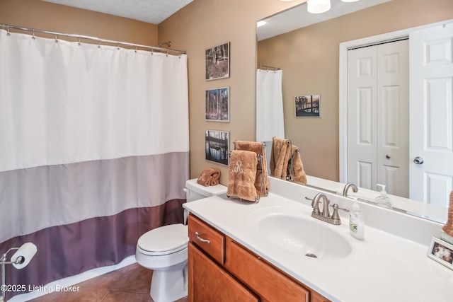 bathroom with toilet, tile patterned flooring, and vanity