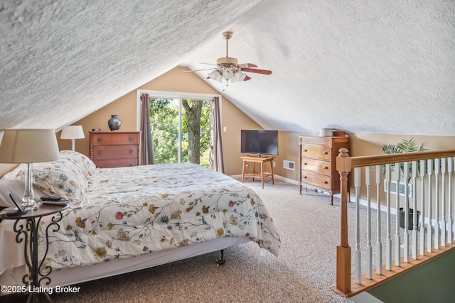 bedroom featuring ceiling fan, carpet floors, a textured ceiling, and lofted ceiling