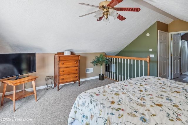 carpeted bedroom featuring ceiling fan, a textured ceiling, and lofted ceiling