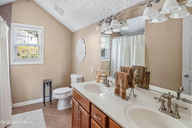 bathroom featuring toilet, tile patterned flooring, lofted ceiling, a textured ceiling, and vanity