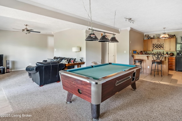 playroom with indoor bar, light tile patterned flooring, billiards, a textured ceiling, and ornamental molding