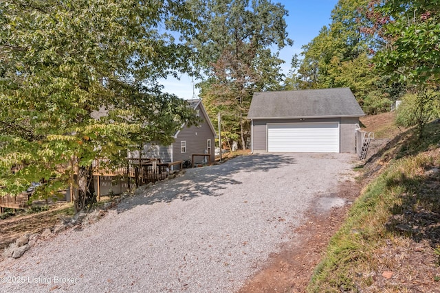 view of front of house featuring a garage and an outbuilding