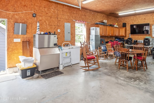 garage with electric panel and washer / dryer