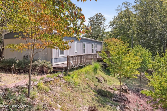 rear view of property with a wooden deck