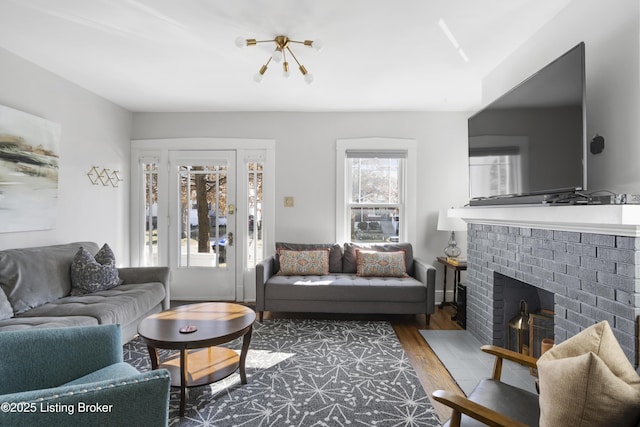 living room featuring a fireplace and dark wood-type flooring