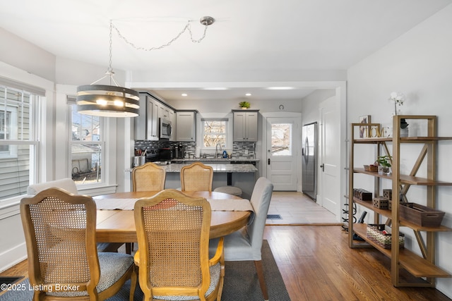 dining area with wood-type flooring and sink