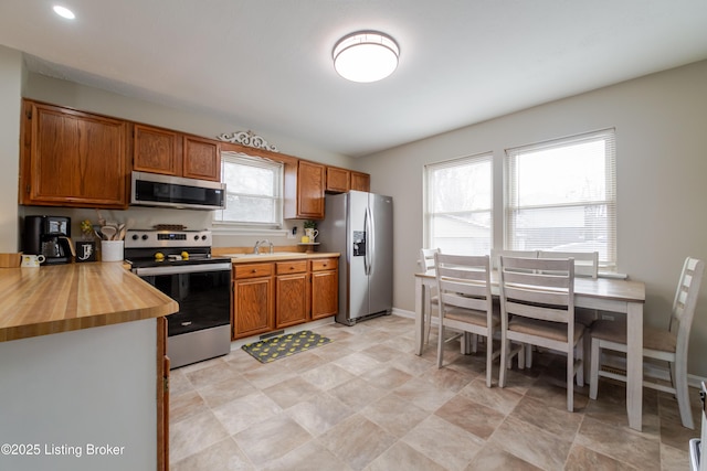 kitchen with appliances with stainless steel finishes and plenty of natural light