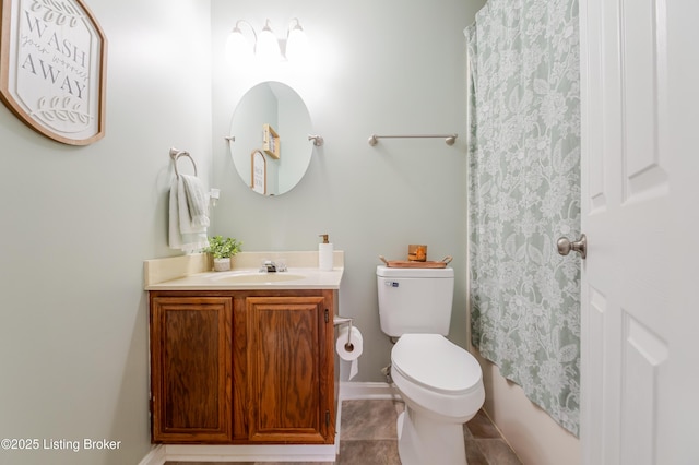 bathroom with toilet, vanity, and tile patterned flooring