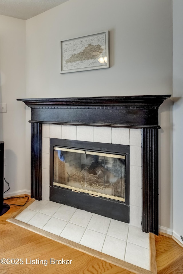 interior details featuring wood-type flooring and a fireplace