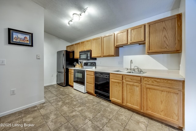 kitchen featuring light tile patterned flooring, sink, a textured ceiling, track lighting, and black appliances