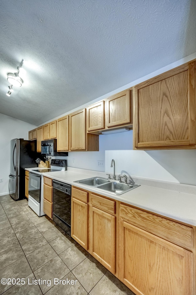 kitchen with light brown cabinetry, sink, a textured ceiling, light tile patterned floors, and black appliances