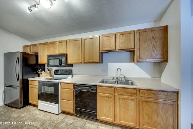 kitchen with sink, black appliances, a textured ceiling, and light tile patterned flooring