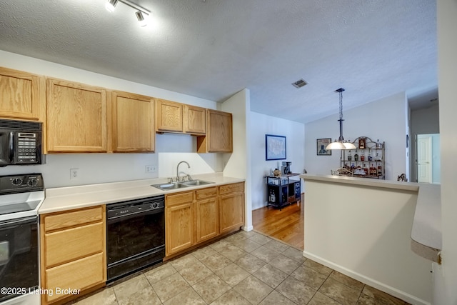 kitchen featuring pendant lighting, sink, black appliances, a textured ceiling, and light tile patterned flooring