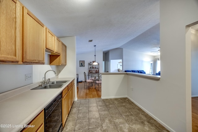 kitchen featuring lofted ceiling, sink, dishwasher, a textured ceiling, and decorative light fixtures