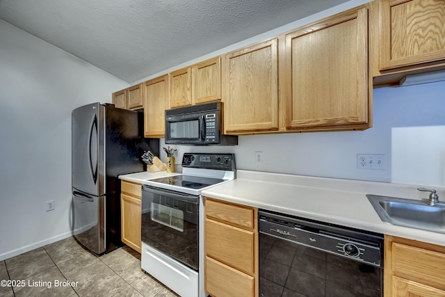 kitchen featuring lofted ceiling, light brown cabinetry, sink, a textured ceiling, and black appliances