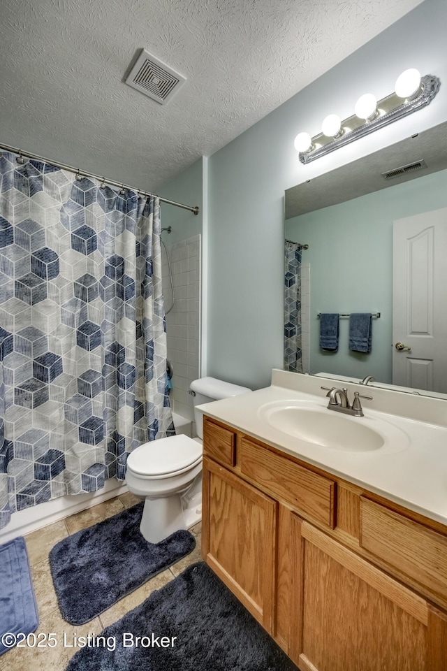 full bathroom with tile patterned floors, toilet, a textured ceiling, vanity, and shower / bath combo