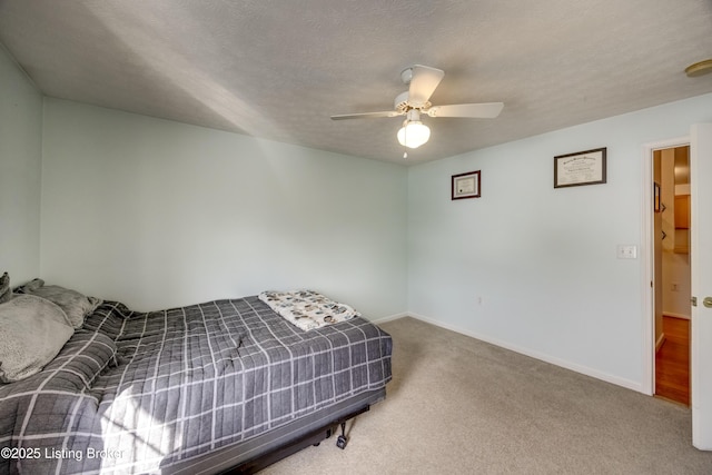 carpeted bedroom with a textured ceiling and ceiling fan